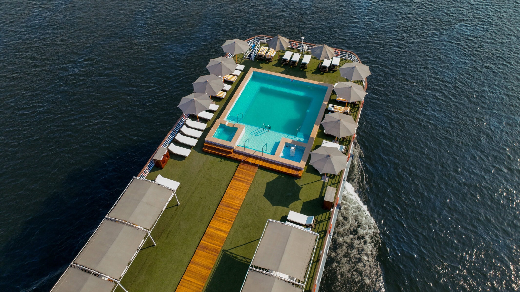 Aerial view of sun deck aboard M/S City and Sea Adonis with swimming pool and loungers.