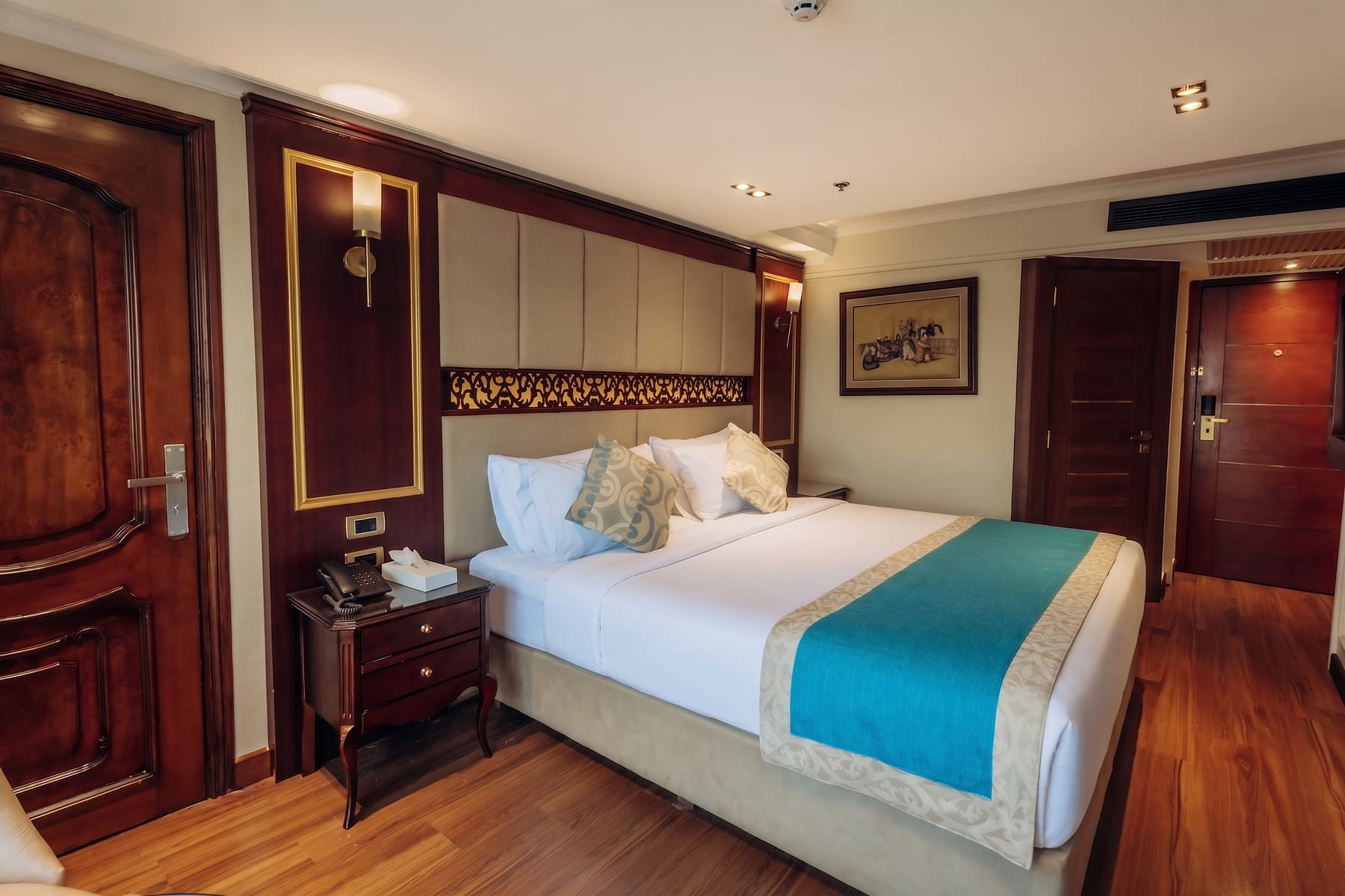 Elegant double bed cabin aboard the M/S City and Sea Adonis with warm wood accents