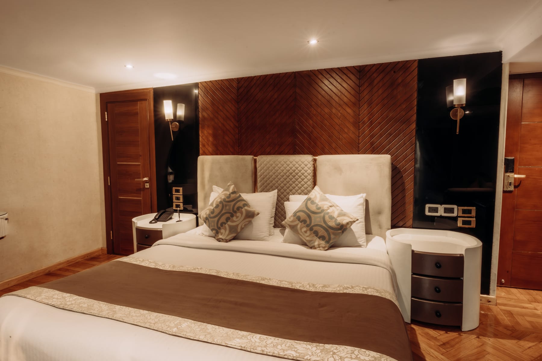Junior Suite king bed and walnut wall, M/S City and Sea Adonis